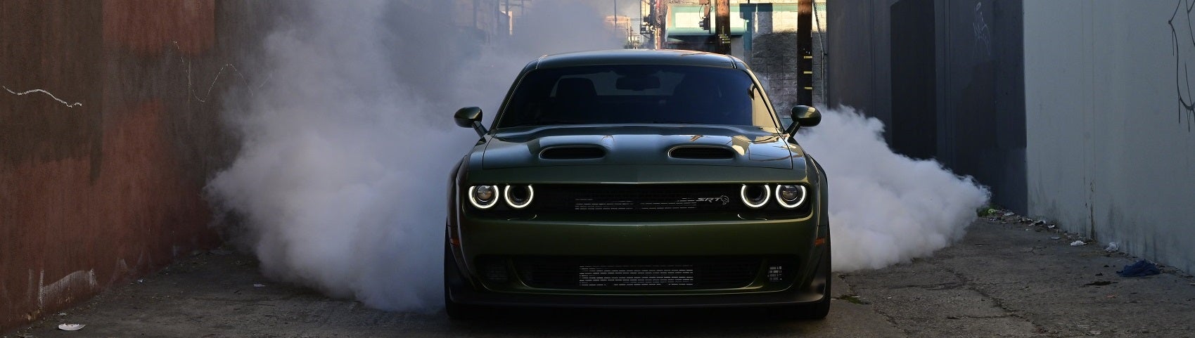 Dodge Challenger parked in an alley with smoky background